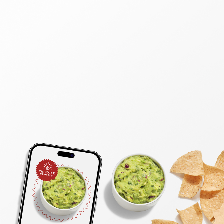 A side of freshly made Guacamole and Tortilla Chips laying beside a phone with the Chipotle Rewards Badge.